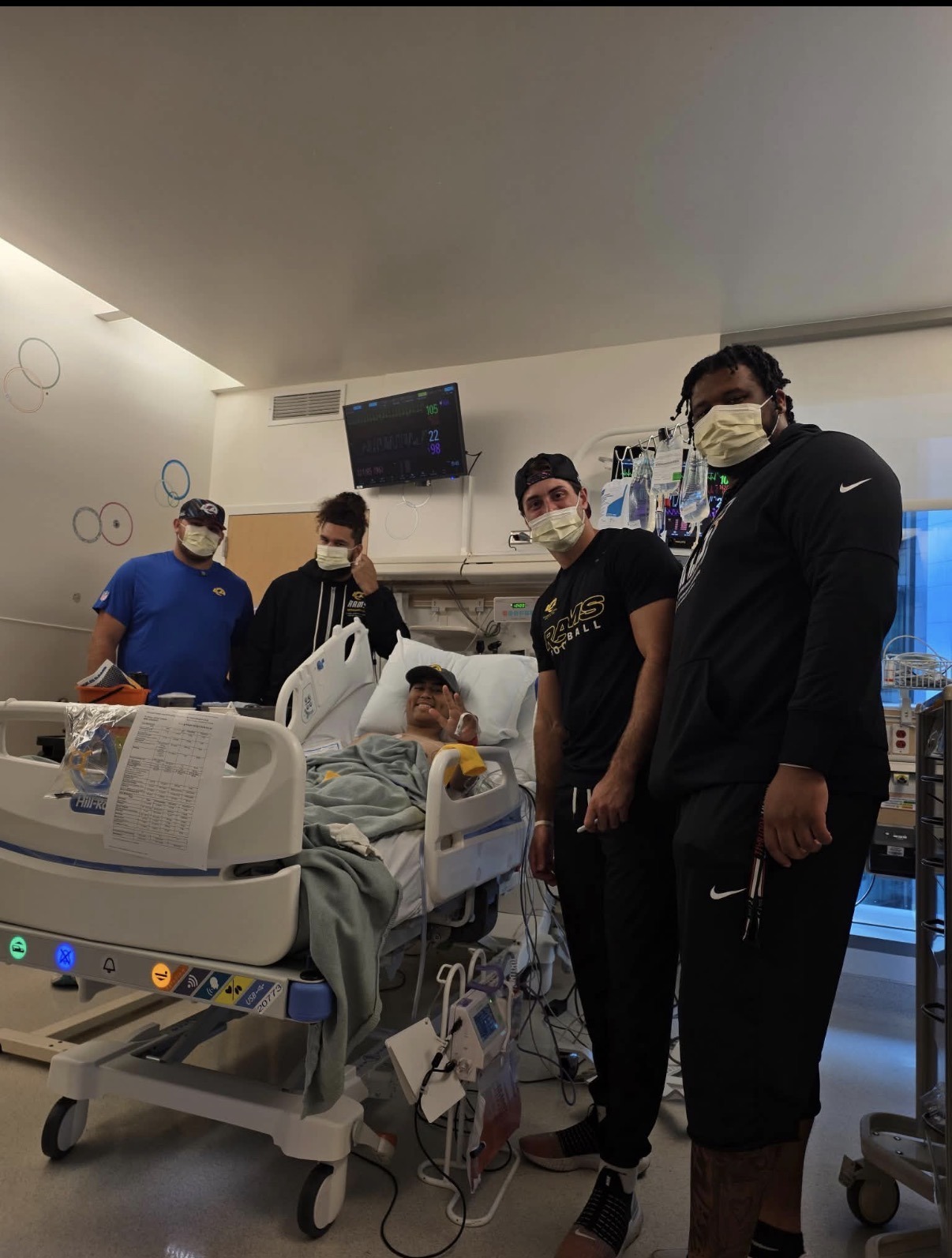 Trenchkid in his hospital bed with Rams players visiting